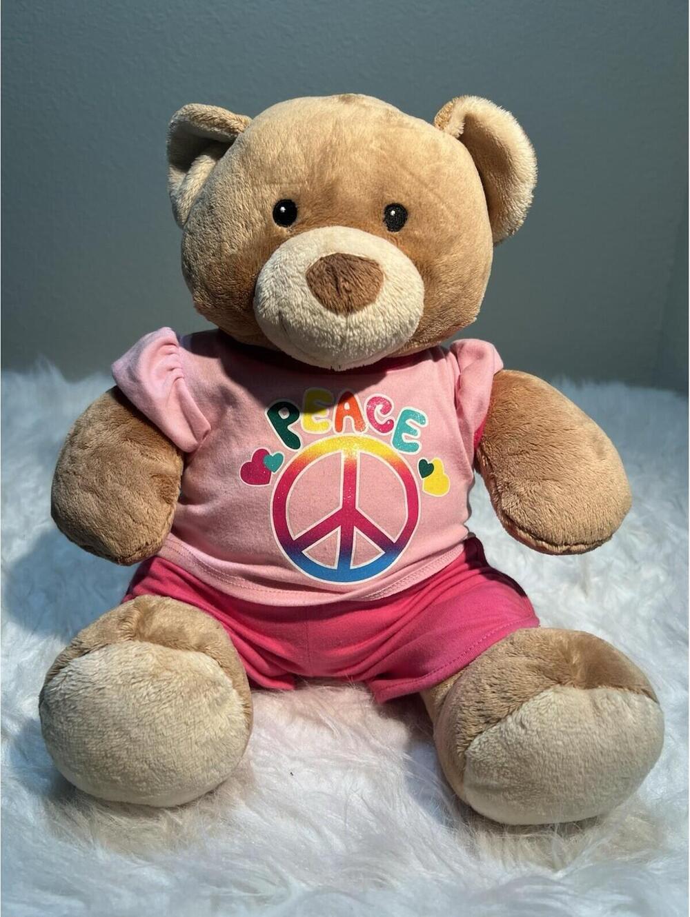 Build-A-Bear Workshop tan teddy bear wearing a pink "Peace" graphic Top